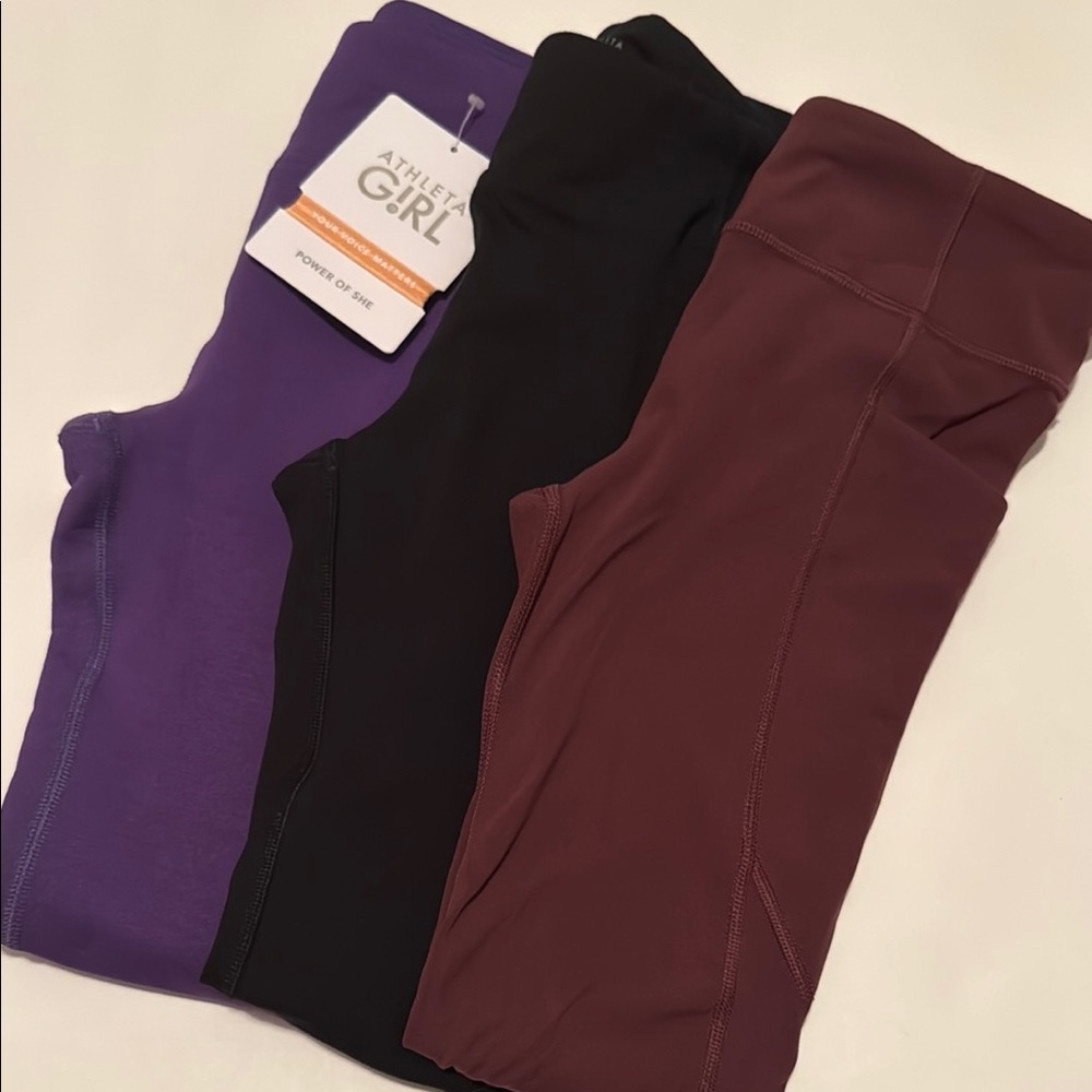Three Athleta Kids Leggings - Purple, Black, and Burgundy